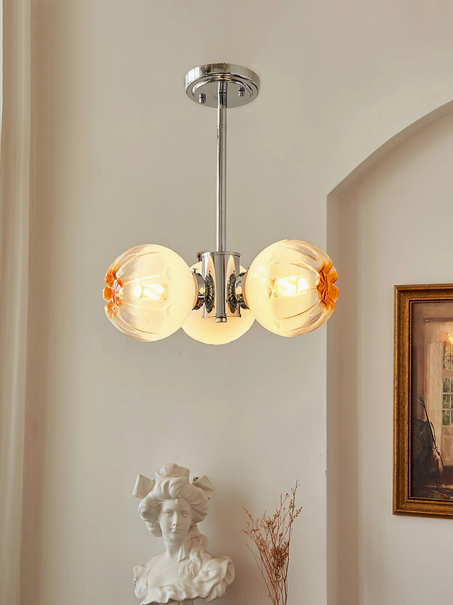 3-head Flower Bud Chandelier with clear amber gradient glass shades and polished chrome in French arched room
