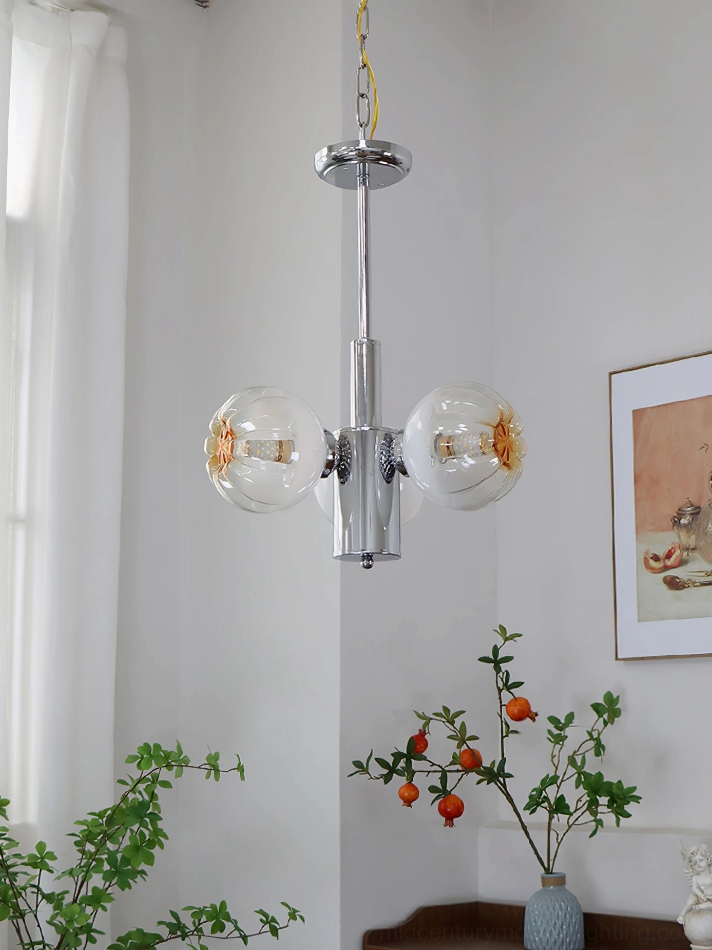 3-light clear glass ball chandelier with transparent shades and chrome frame in minimalist modern interior