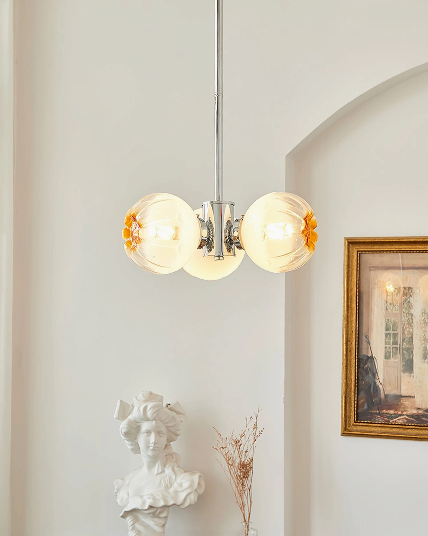 3-head Flower Bud Chandelier illuminated in classical French room with bust sculpture and dried florals