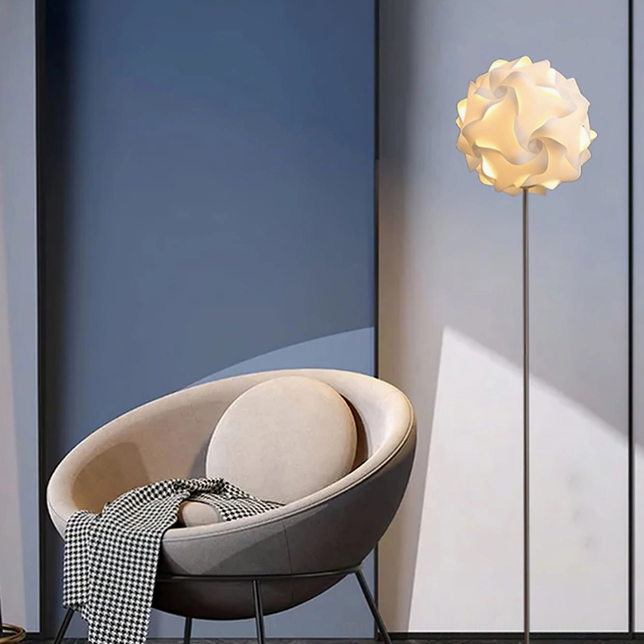 Warm glowing flower floor lamp creating intimate ambiance in leisure corner with dark blue accent wall