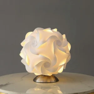 Modern flower lamp with swirl petal design on marble side table warm LED glow
