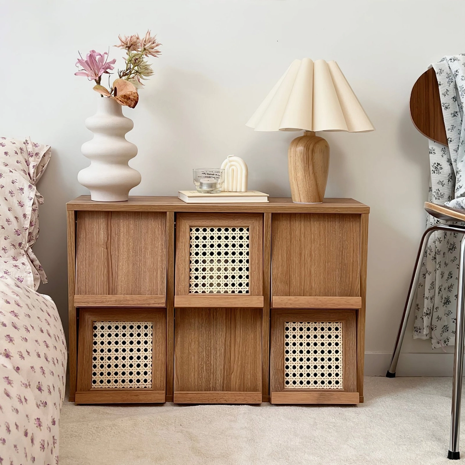 Vintage pleat table lamp on bedroom nightstand creating warm ambient light in cozy neutral bedroom decor setting