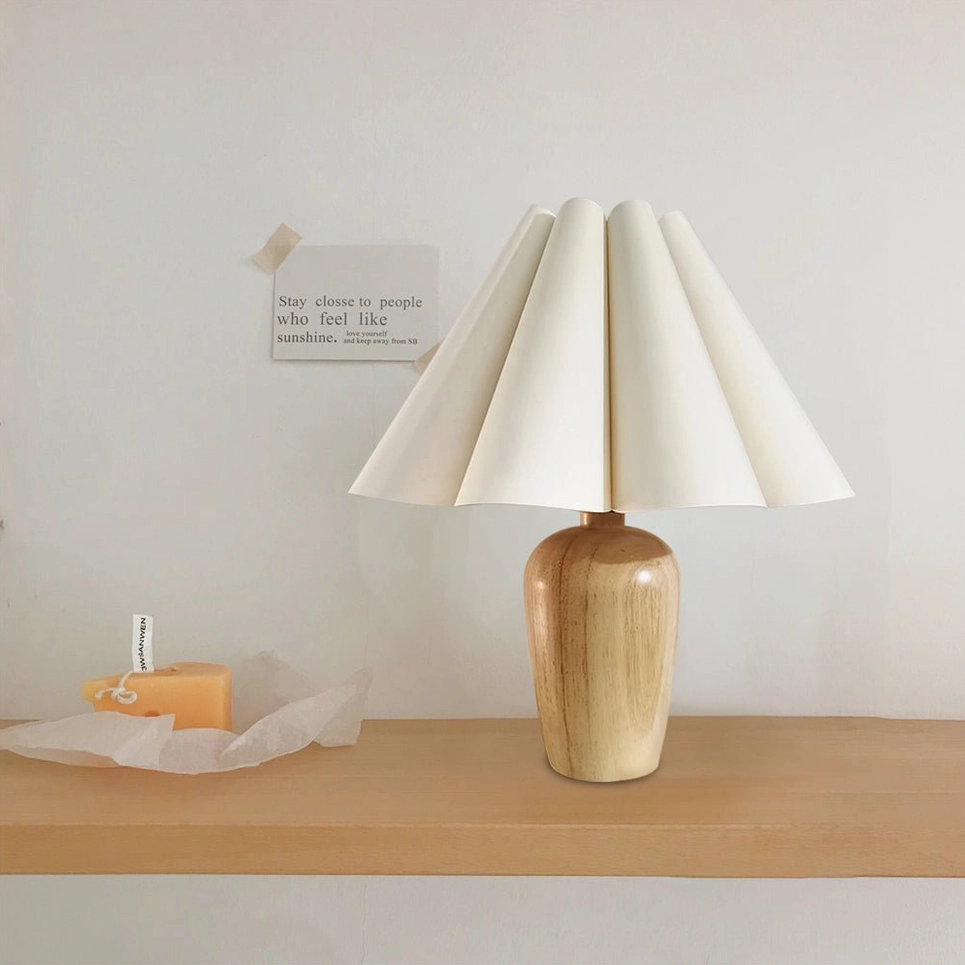 Wooden table lamp front view positioned on floating shelf with warm neutral home decor and simple styling