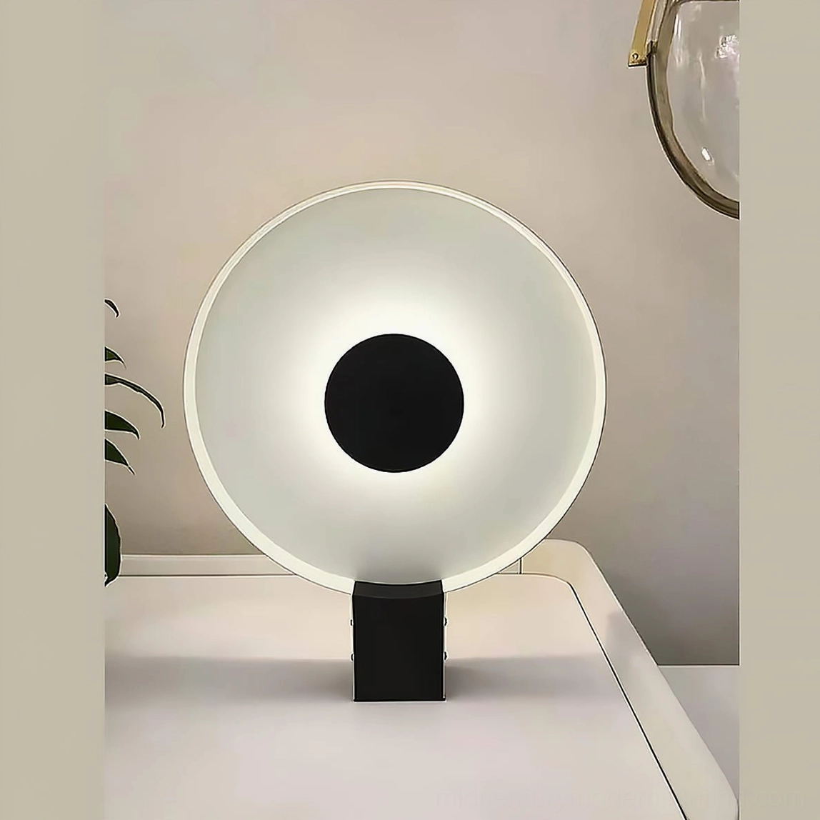 Round Flying Saucer lamp on bedroom nightstand emitting soft warm ambient glow, low angle perspective