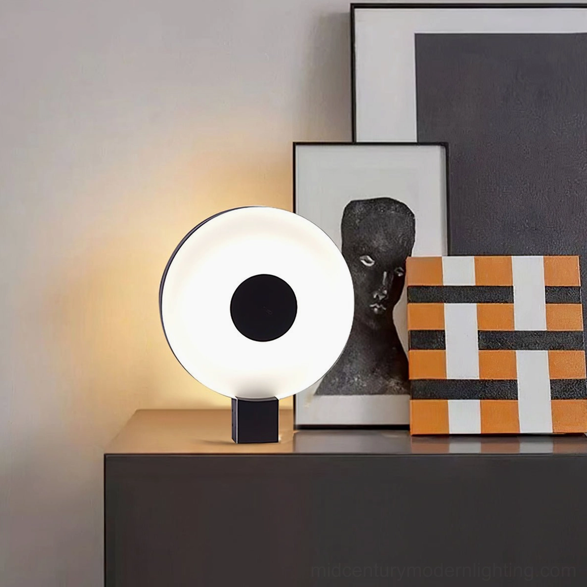 Round Flying Saucer LED lamp on living room side cabinet with contemporary art wall prints decoration