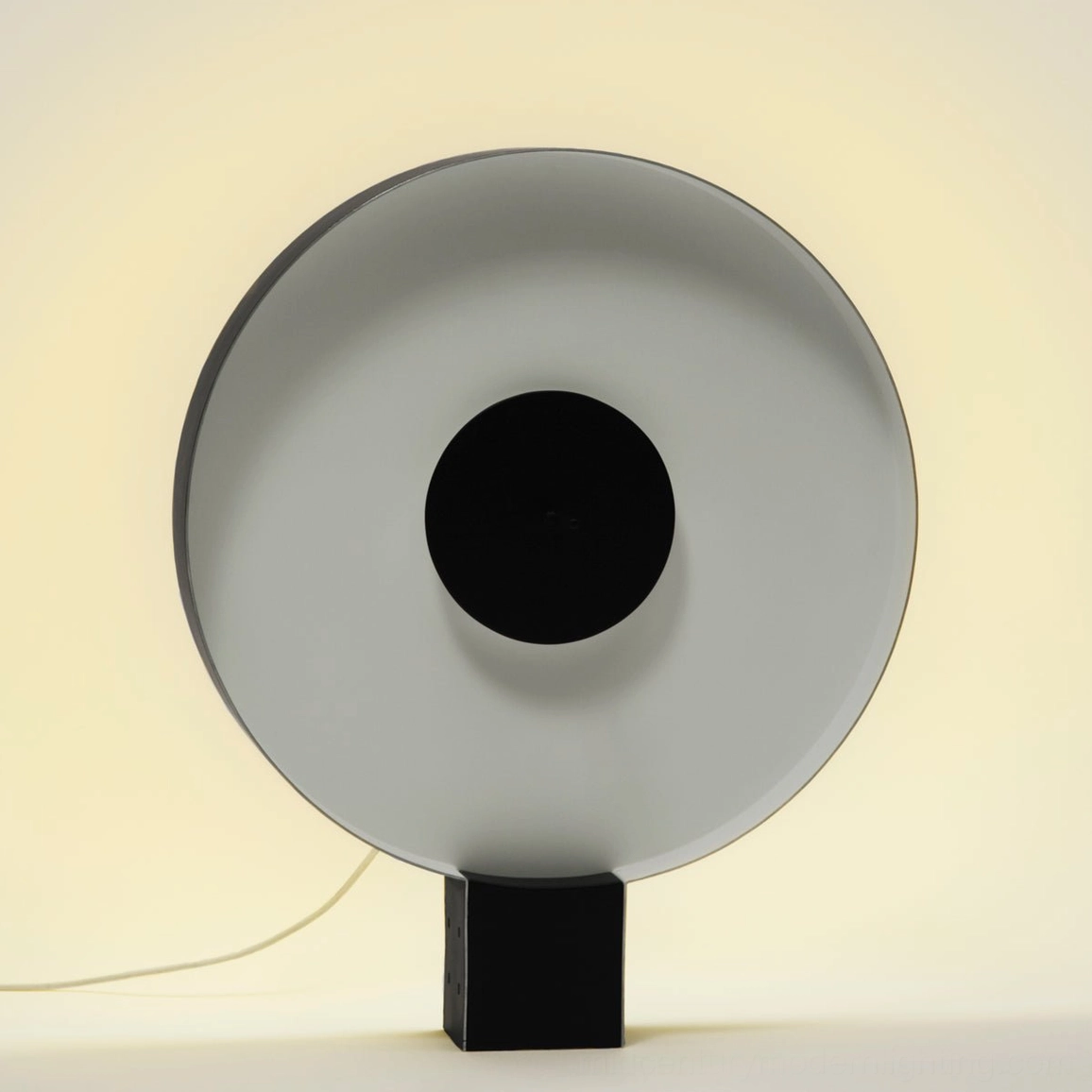 Round Flying Saucer table lamp with smooth matte two-tone black and white finish, overhead studio shot