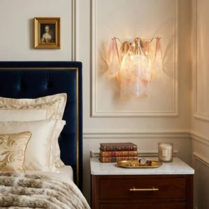 Mid-century modern pink ombré wall sconce mounted on bedroom nightstand, casting warm ambient light with navy tufted headboard backdrop
