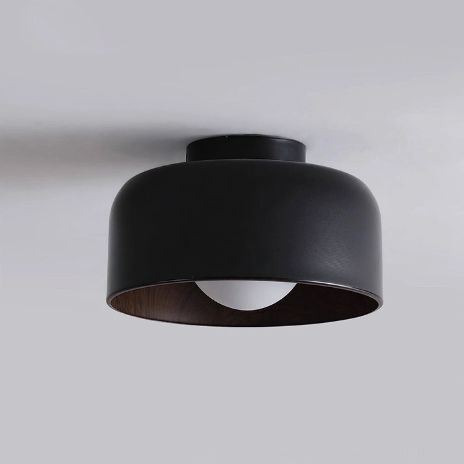 Folkio black flush mount ceiling light front close-up studio shot, cylindrical matte metal design detail