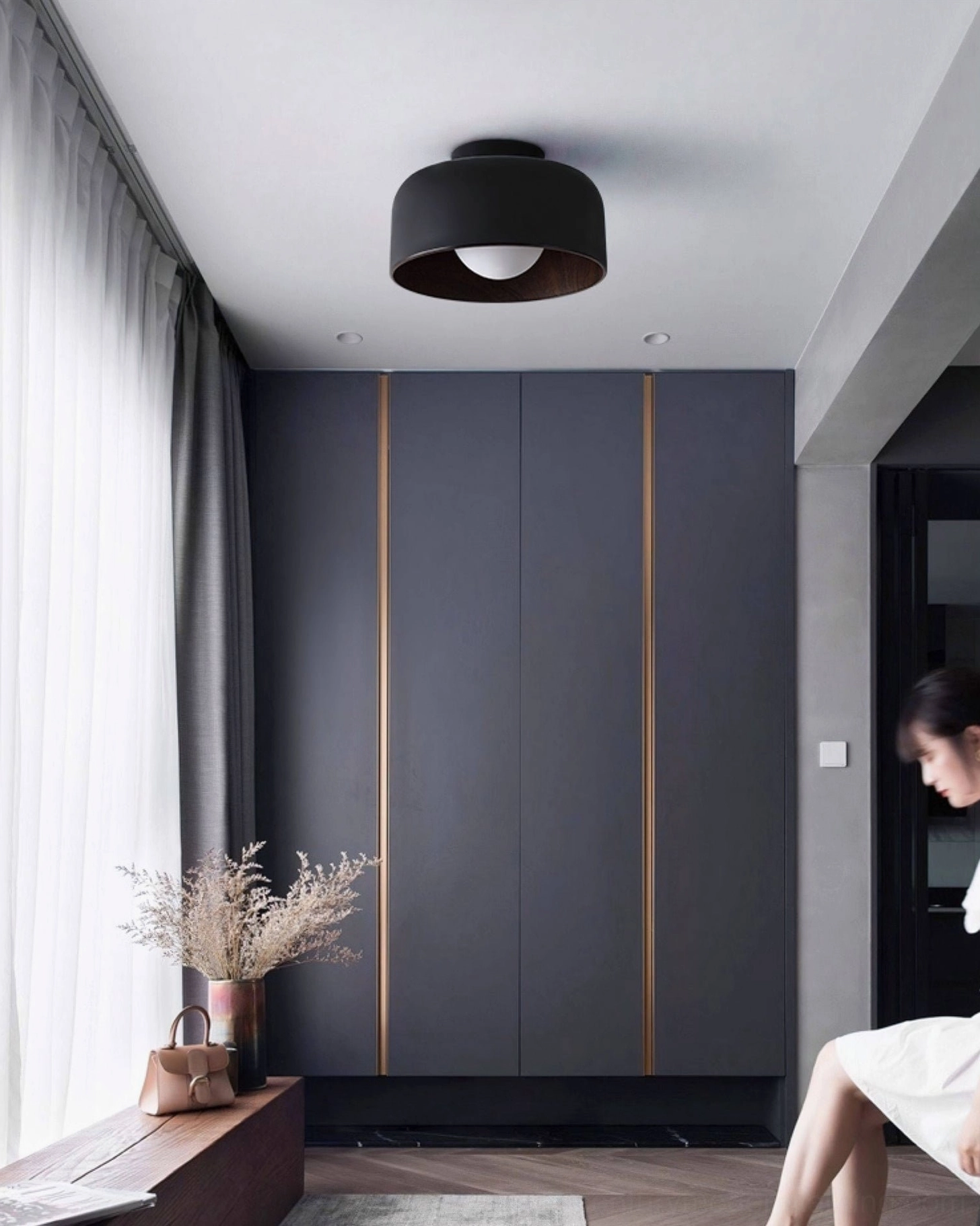 Folkio black matte ceiling light in sleek dark minimalist walk-in closet interior design space