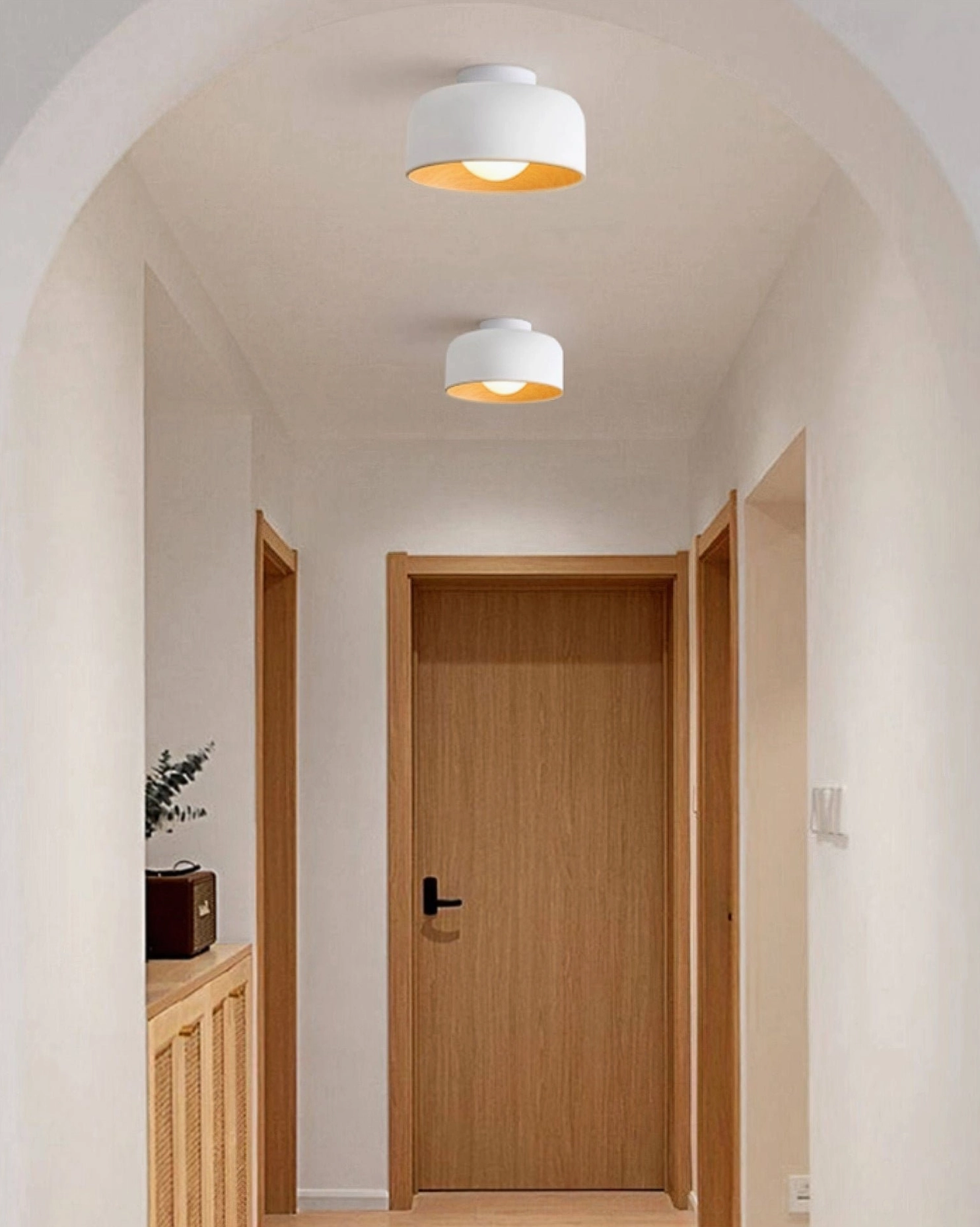 Twin Folkio white ceiling lights installed along residential arched hallway corridor, minimalist aesthetic