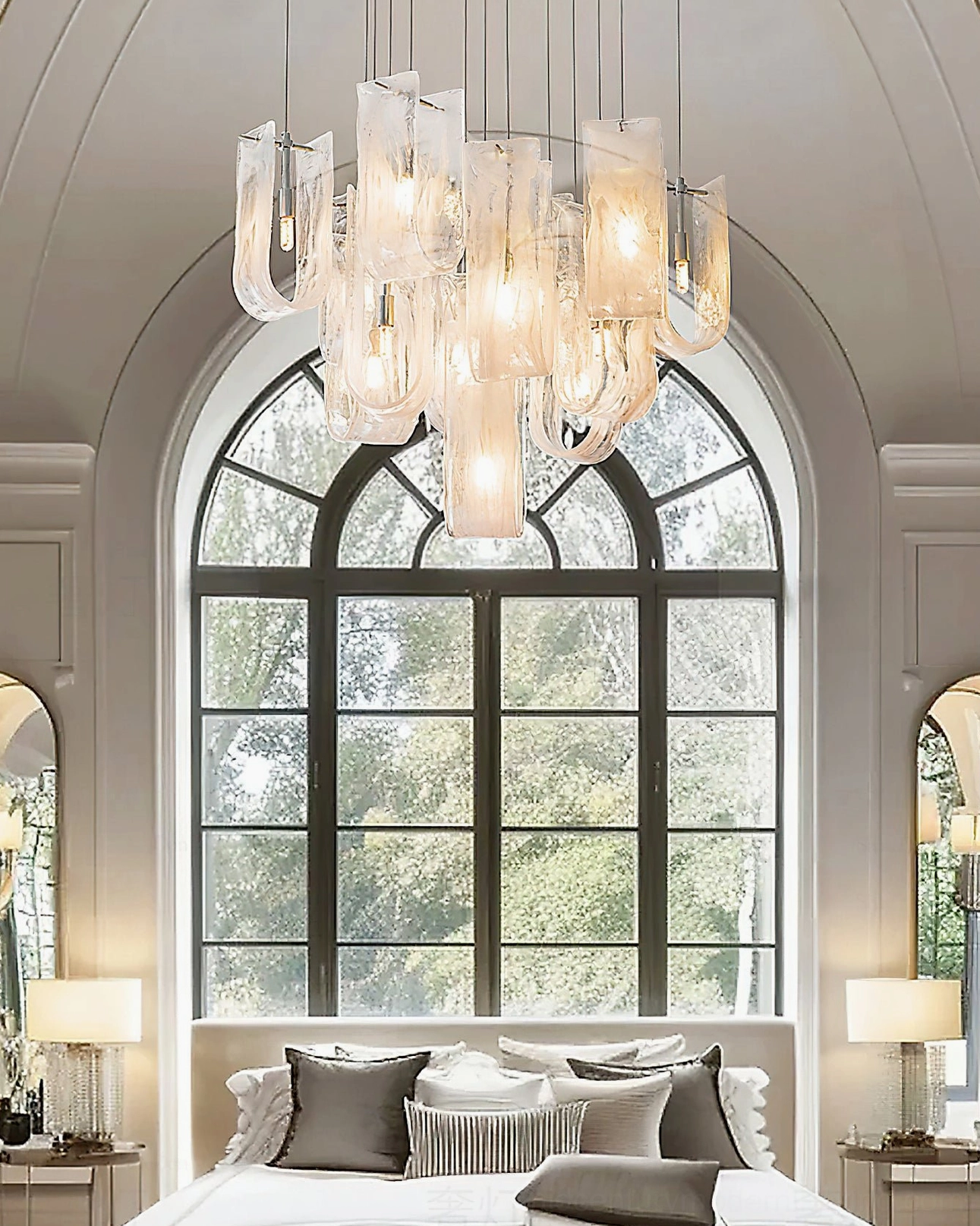 Fontaine sculptural glass chandelier in neoclassical master bedroom with arched vintage window, warm bedroom lighting