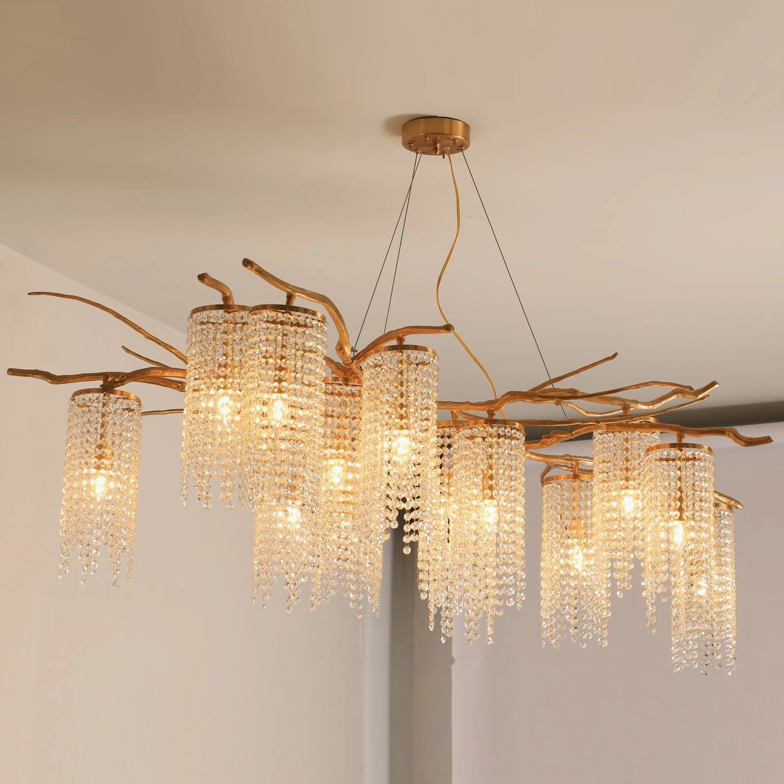 Forest Dawn Chandelier front overhead view showing multiple lit crystal lampshades with warm yellow lighting