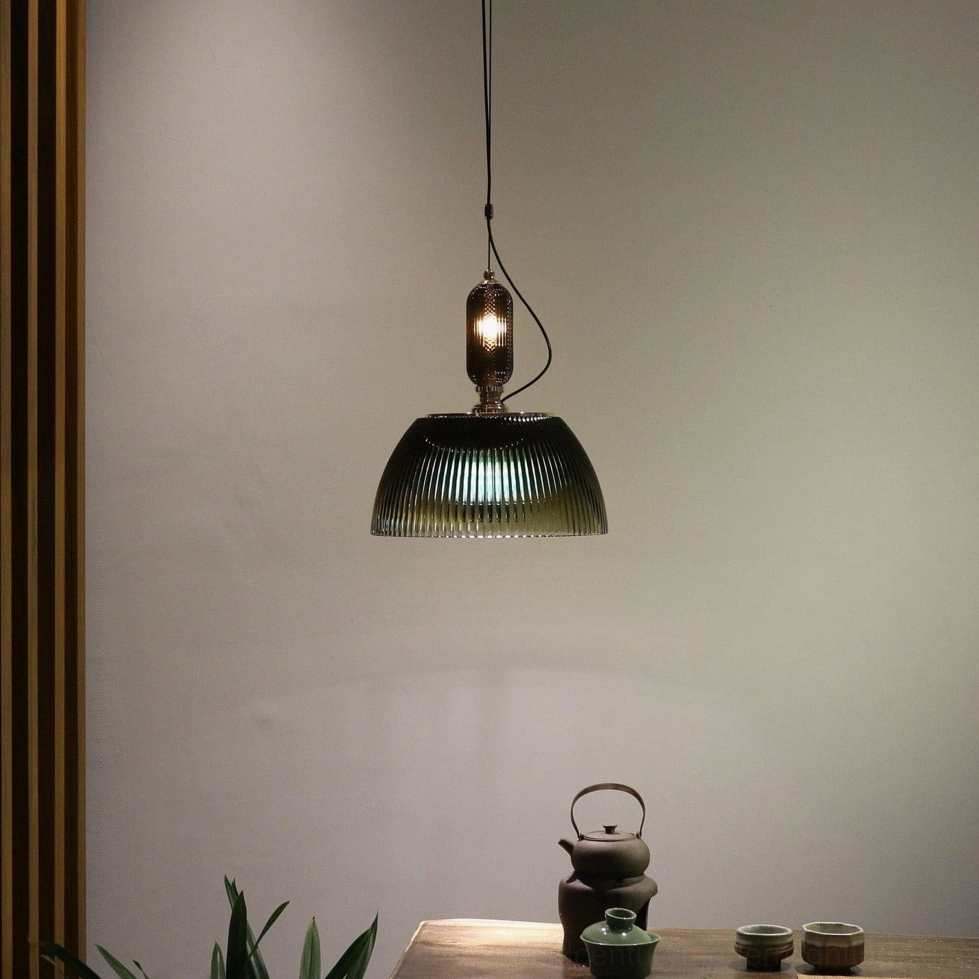 Vintage pendant light fixture with forest green ribbed dome shade suspended from ceiling - architectural detail