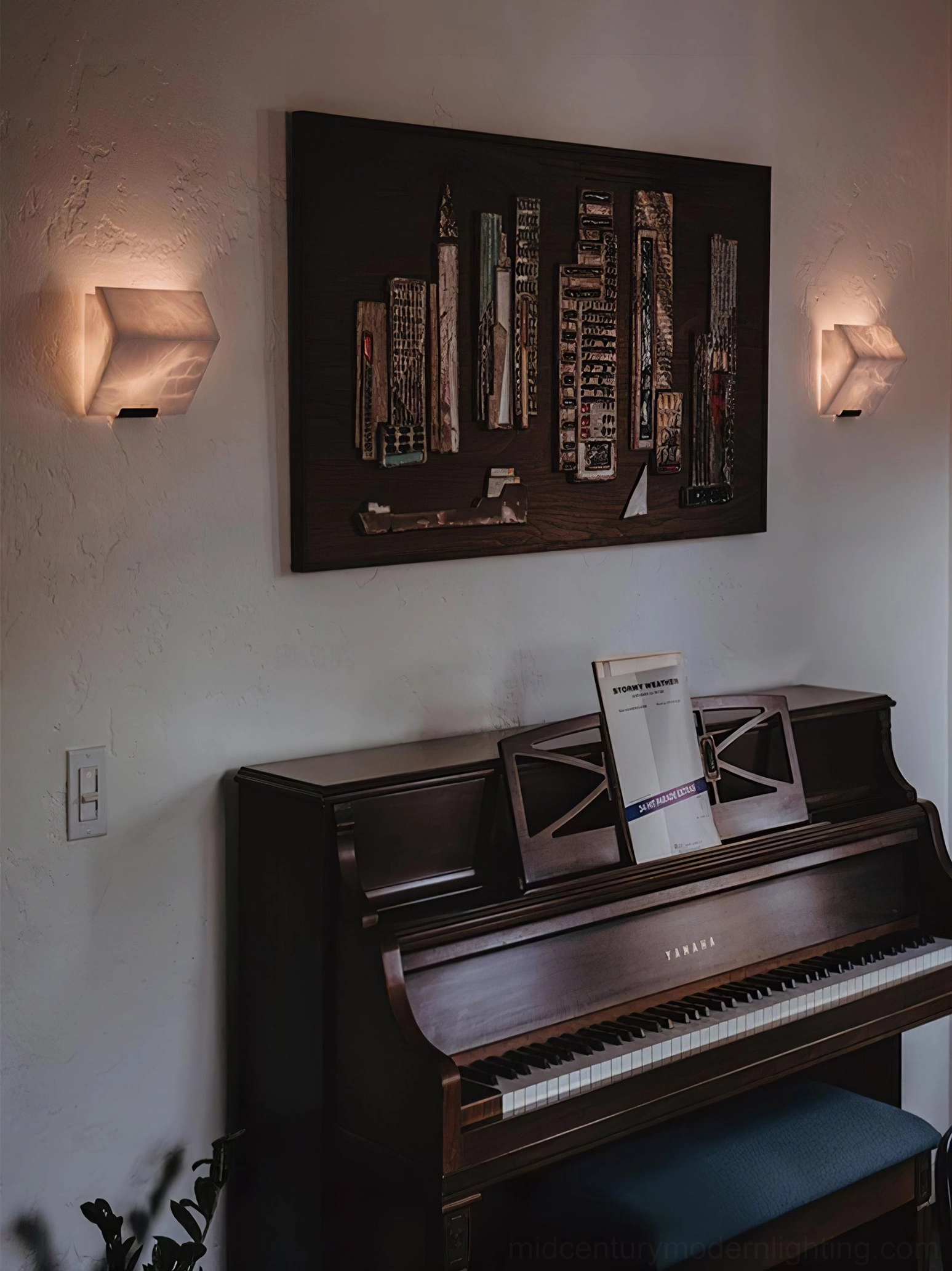 Four-light stacked alabaster wall lamp showcasing full height sculptural design with warm LED illumination