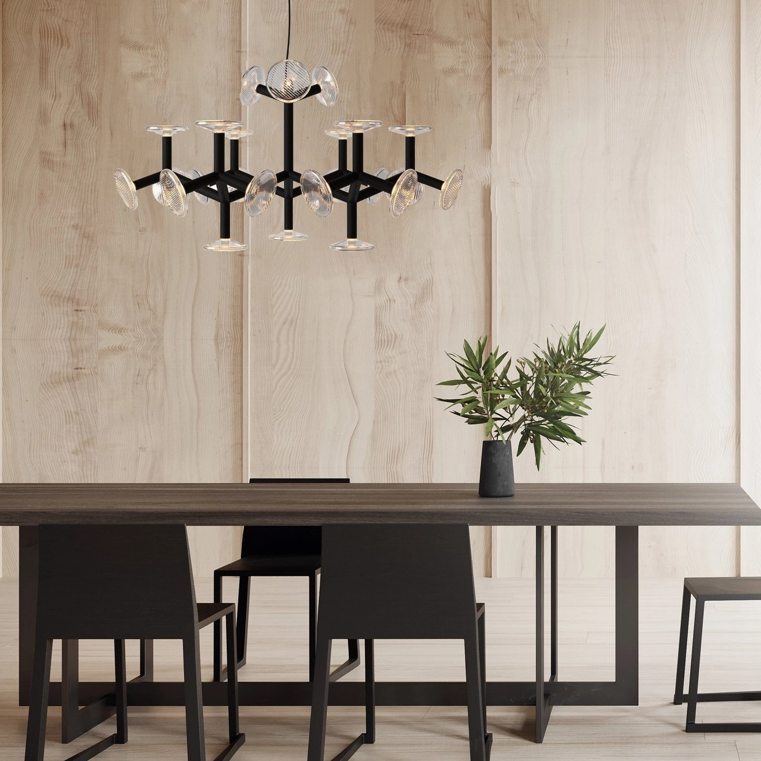 Black and gold geometric chandelier in Nordic dining room with natural light