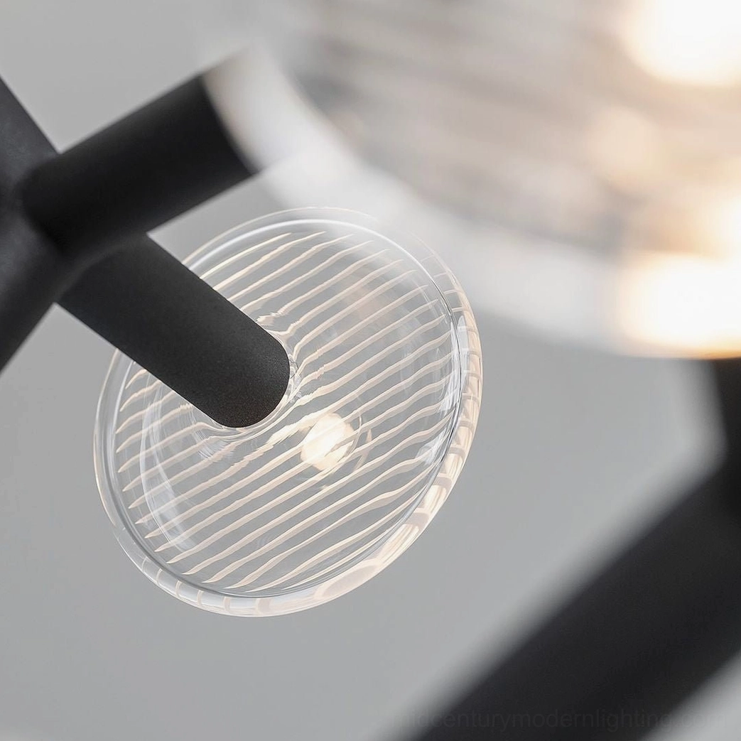Close-up detail of matte black metal rod and ribbed clear glass shade component