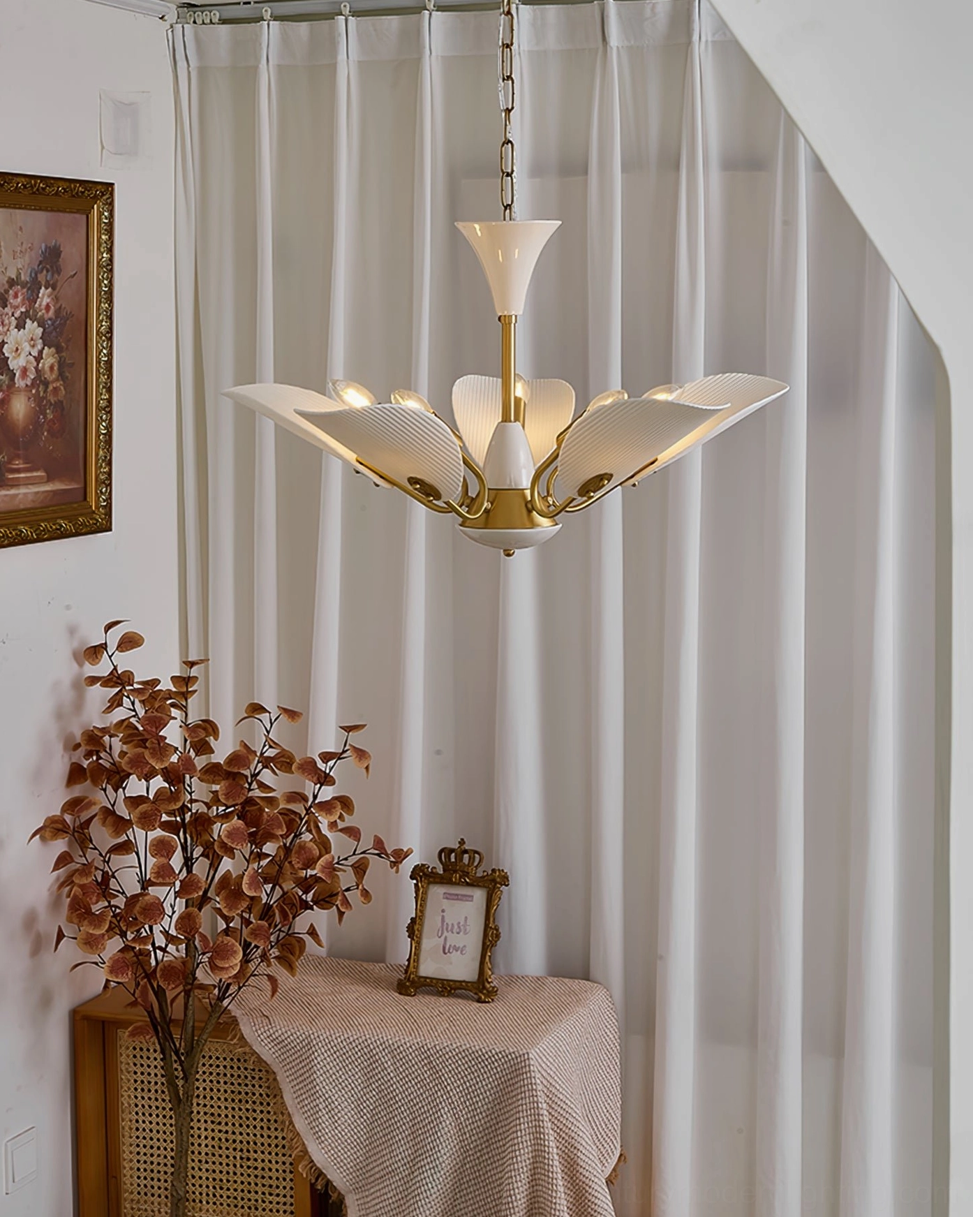 Franco ceramic chandelier artistic angle showing sculptural ceramic petals and polished brass construction
