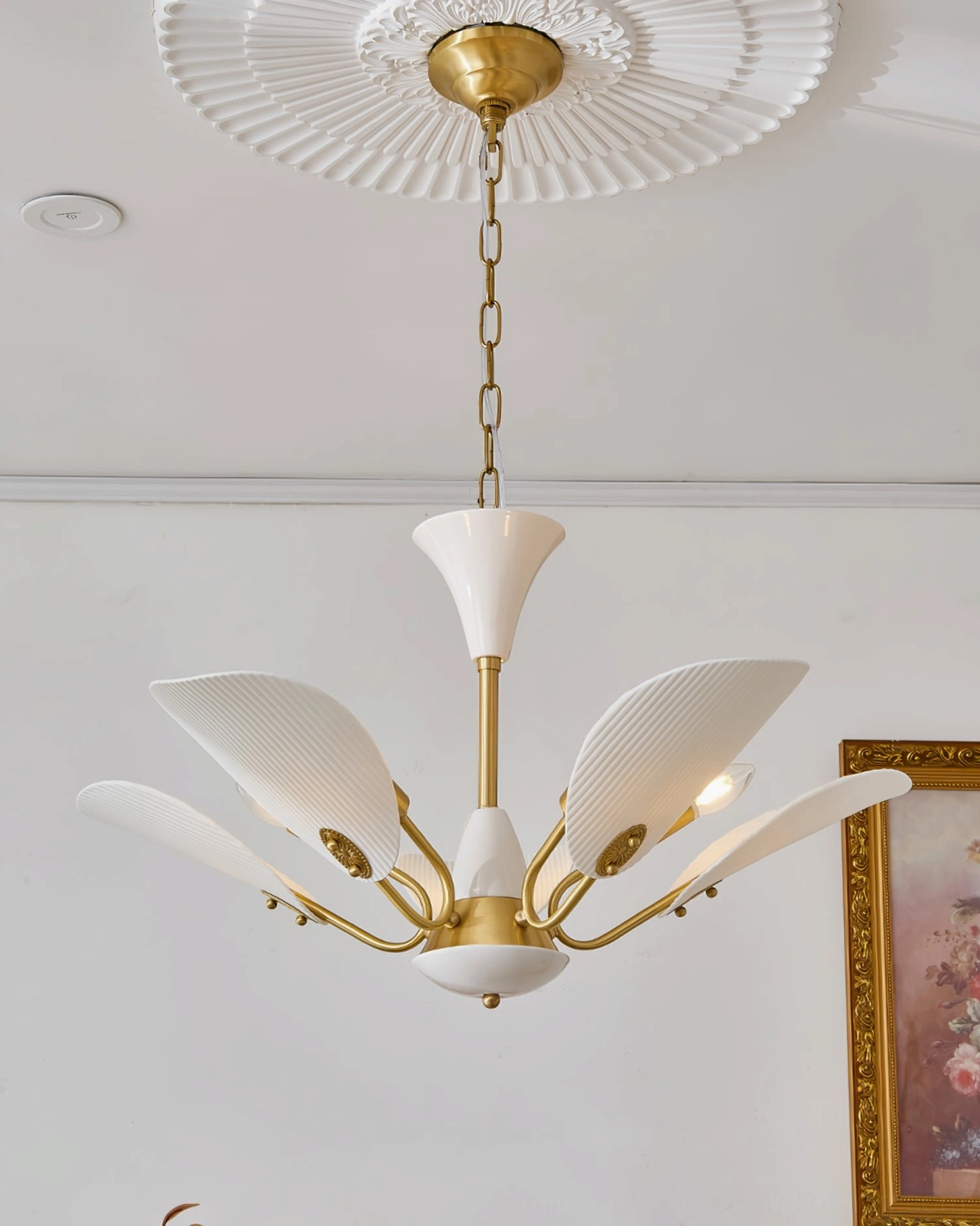Franco ceramic chandelier mounted on ceiling with decorative medallion and three-quarter frontal angle