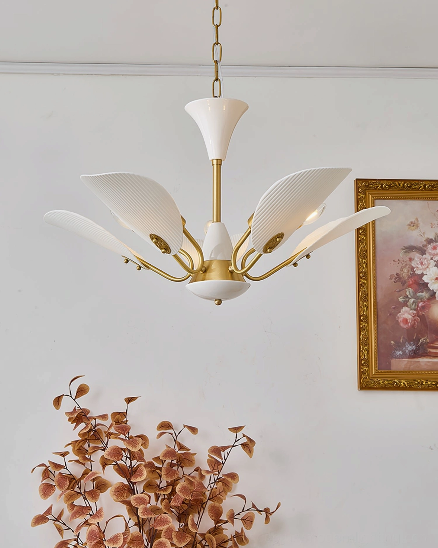 Franco ceramic petal chandelier with lit candle-style bulbs casting warm ambient lighting in living space