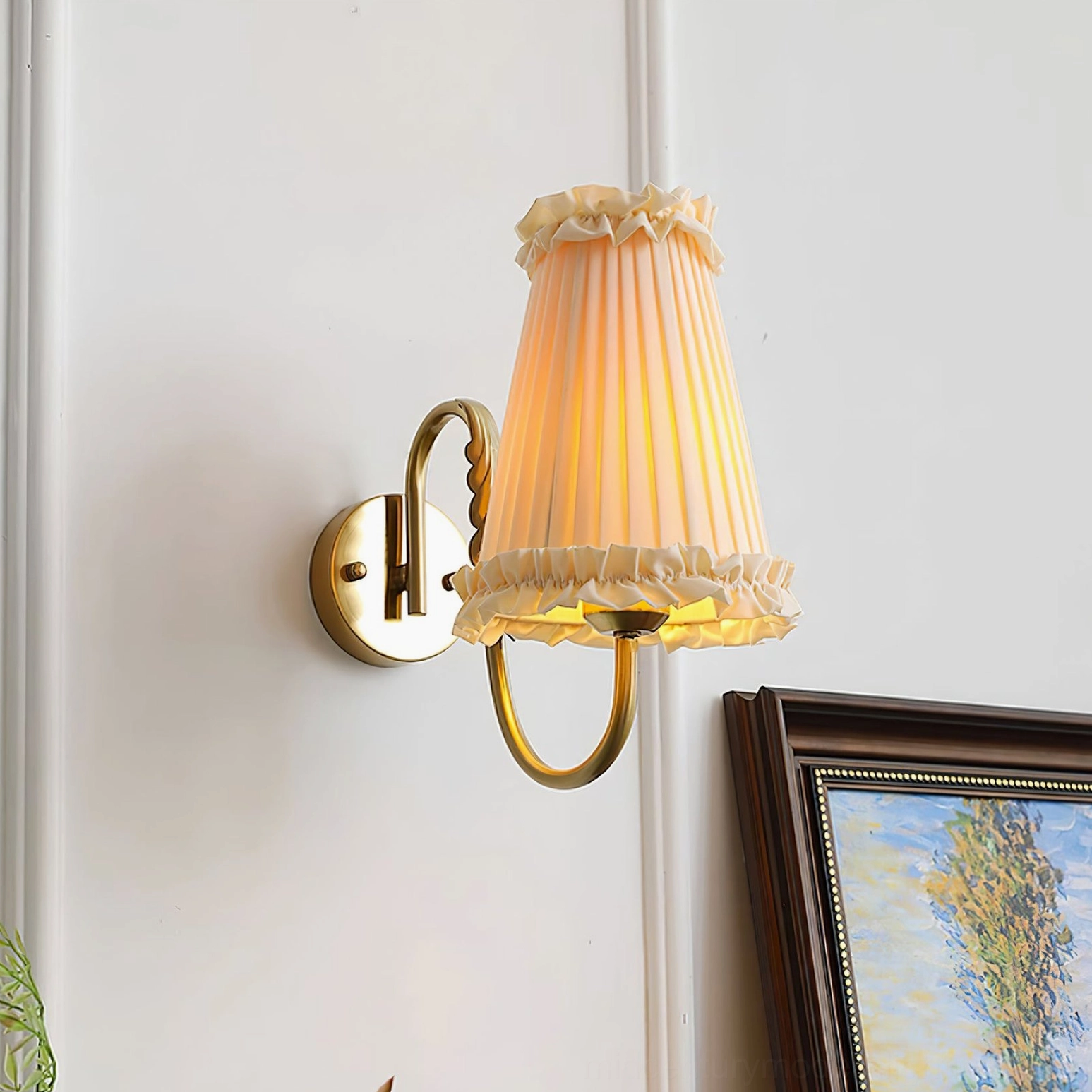 French-style wall sconce with lit warm ambiance surrounded by framed art and green plants