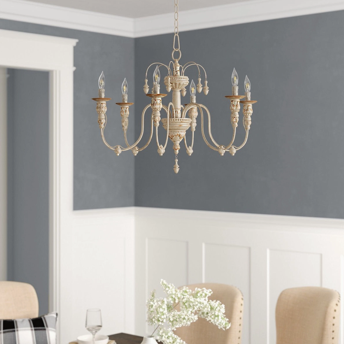 French country style candelabra chandelier in formal dining room with wainscoting and elegant design