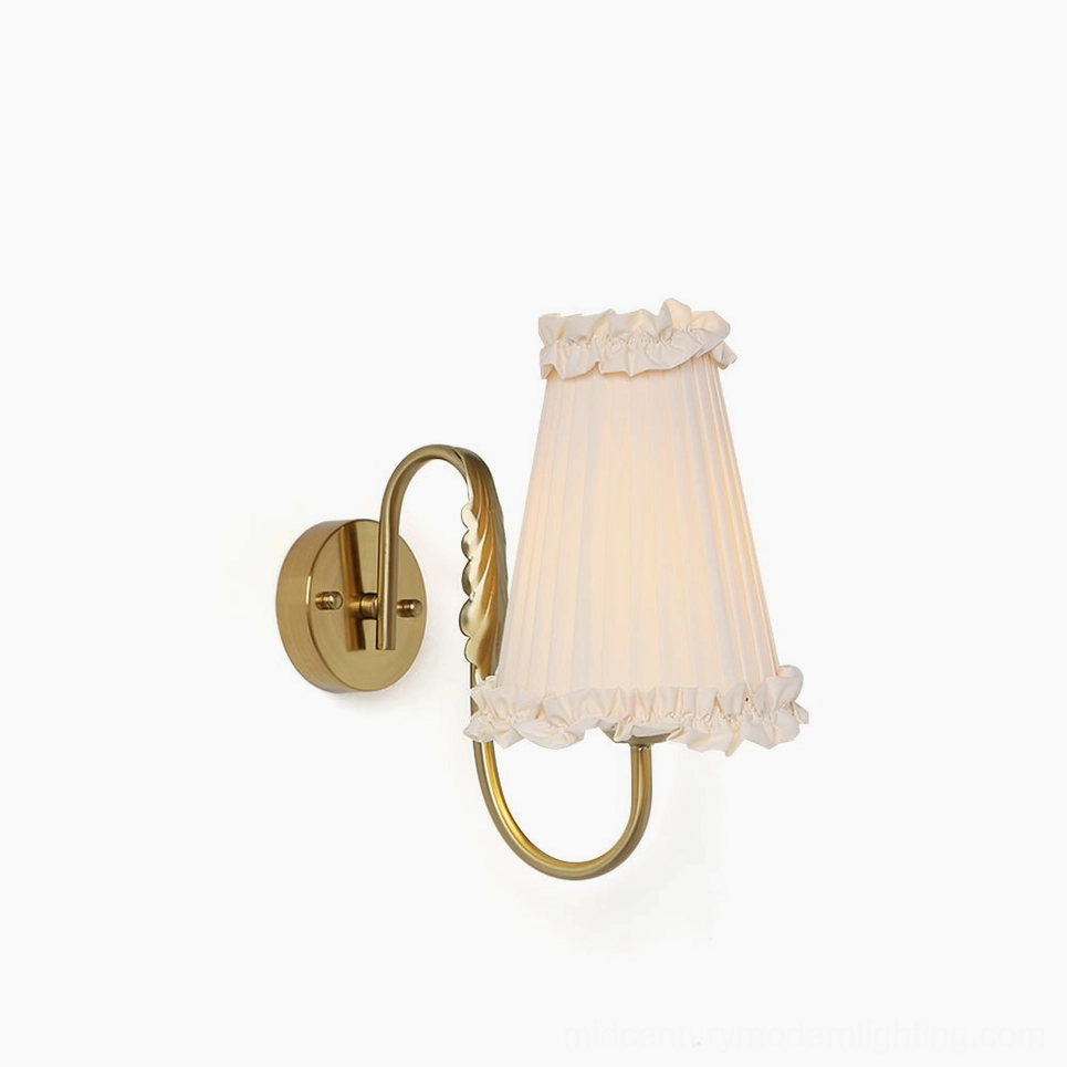 French pleated fabric wall sconce with curved brass arm and beige ruffled shade - front view product photography