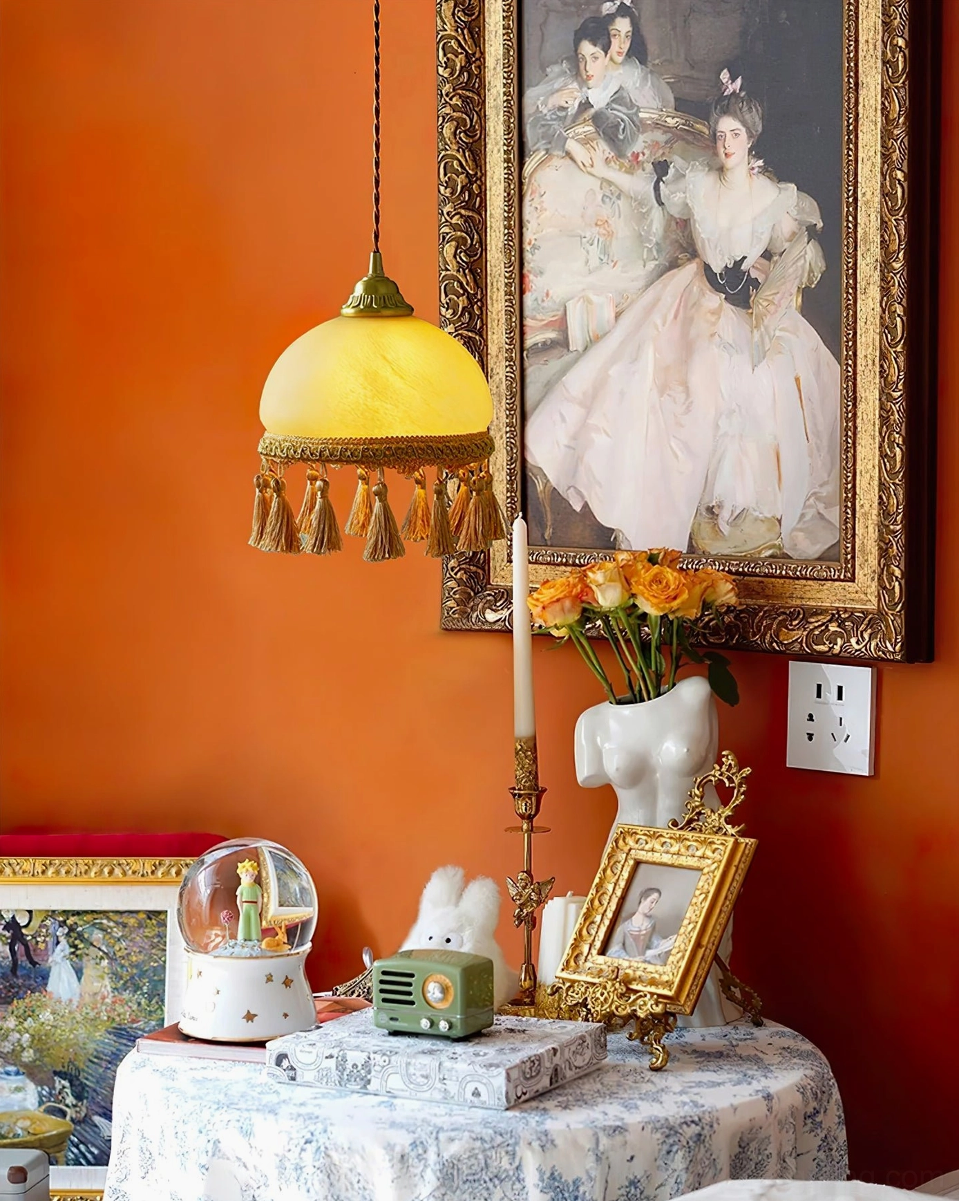 Polished brass French tassel pendant lighting installation showing ceiling mount and cord placement