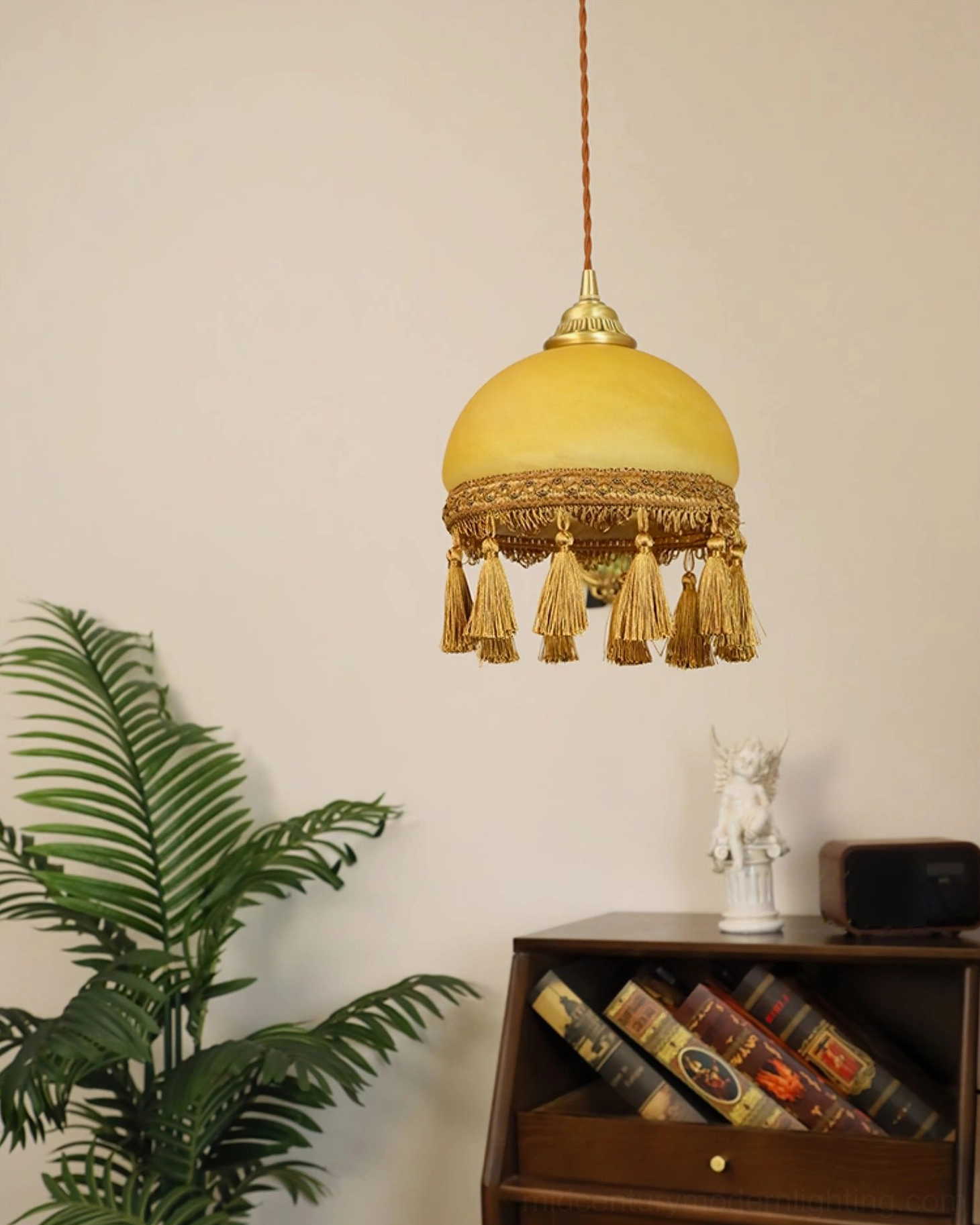French tassel brass pendant light with gold finish and brown tassels in living room bookshelf corner