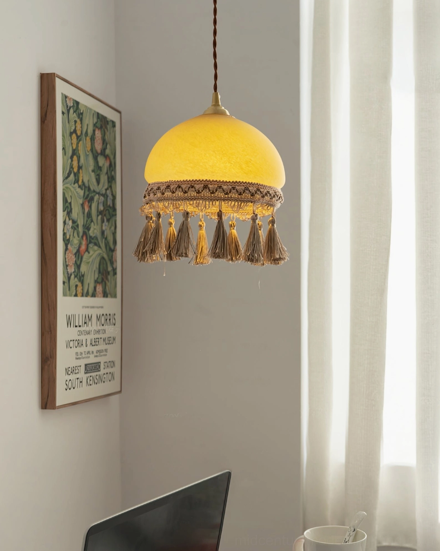 Vintage French tassel brass pendant installed in home study corner with wall art and warm lighting