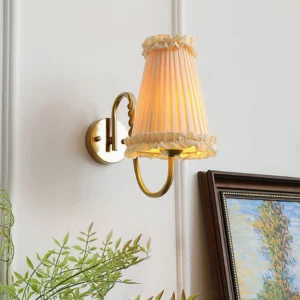Illuminated French-inspired wall lamp with warm light in home interior setting with framed painting