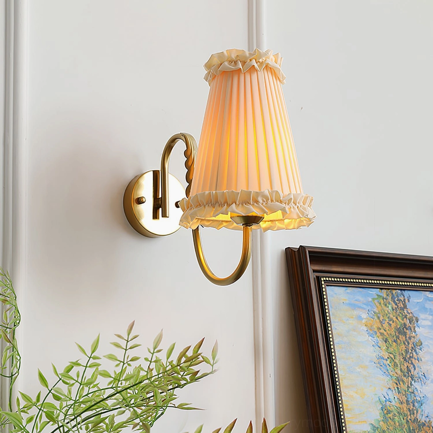 Illuminated French-inspired wall lamp with warm light in home interior setting with framed painting