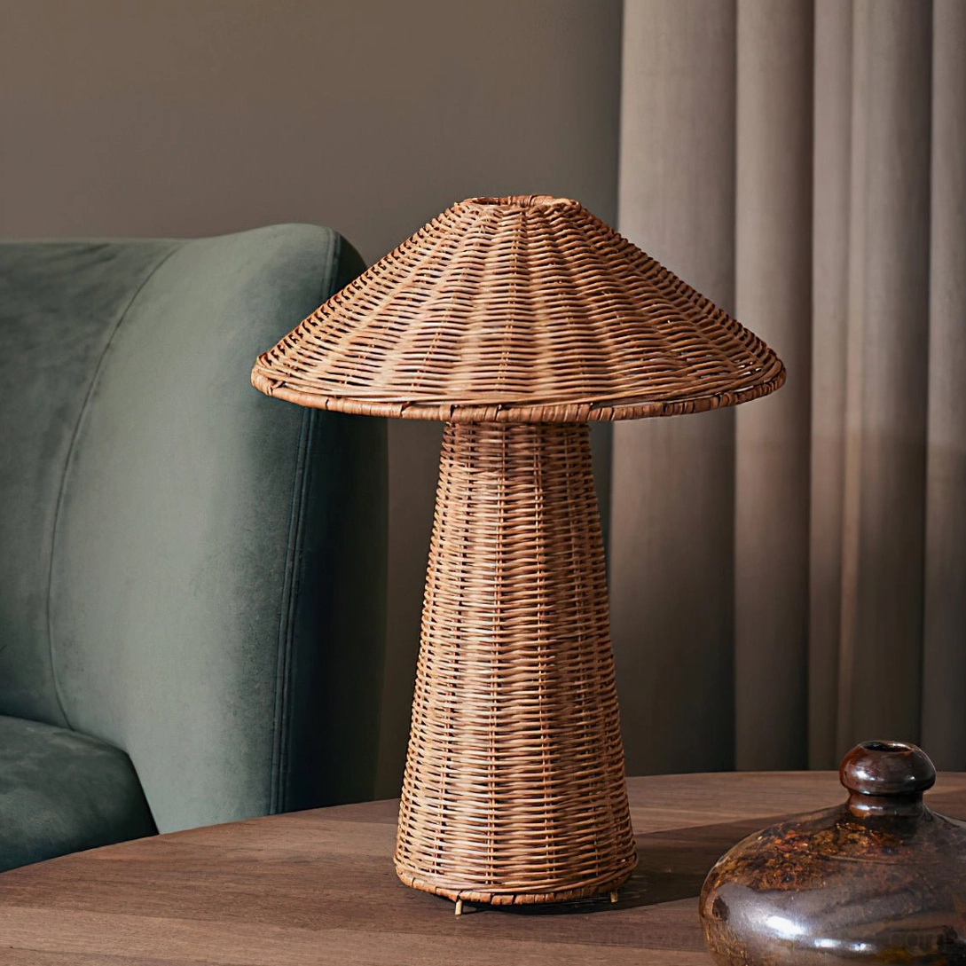 Freya rattan mushroom table lamp three-quarter view beside teal velvet sofa, warm woven texture, mid-century modern living room