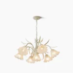 Frosted glass flower chandelier with cream metal frame displayed against white studio background, mid-century modern pendant lighting fixture
