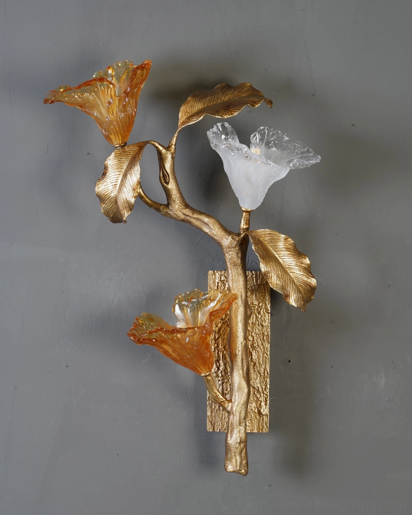 Clear frosted glass lily bloom of brass wall sconce showing diffused light quality and petal form