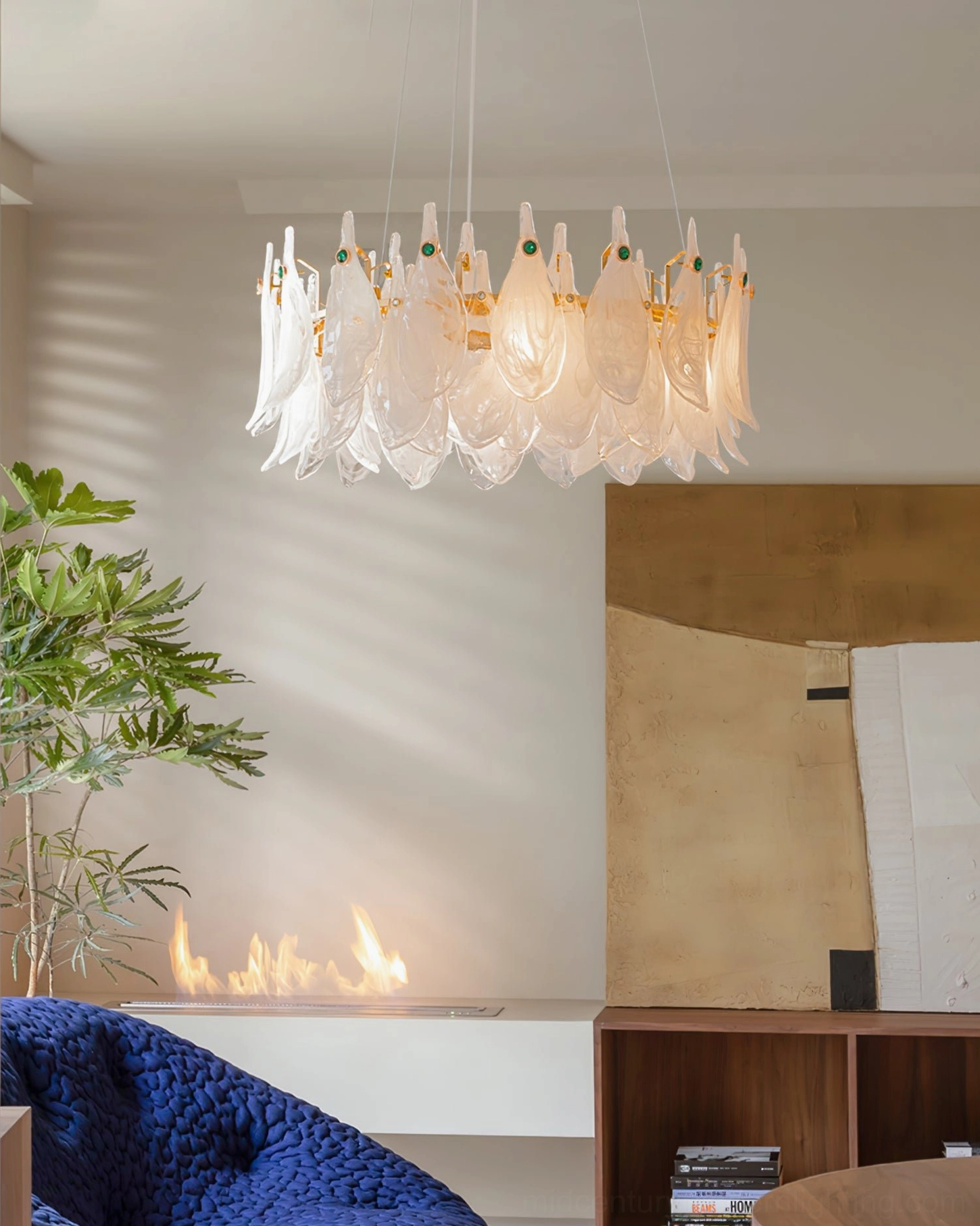 Linear petal glass chandelier over blue velvet sofa in contemporary living room