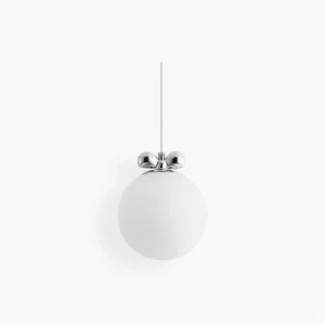 Frosted white glass globe pendant light with polished chrome bow hardware, minimalist studio product view