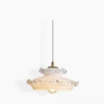 Frosted milk glass pendant light with brass hardware and ruffled clear glass trim - studio product photography