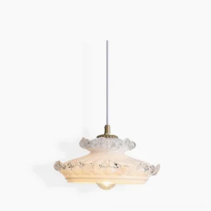Frosted milk glass pendant light with brass hardware and ruffled clear glass trim - studio product photography