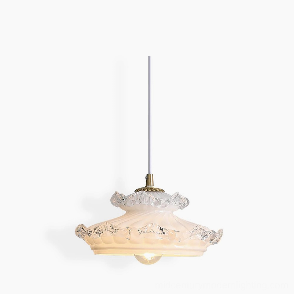 Frosted milk glass pendant light with brass hardware and ruffled clear glass trim - studio product photography