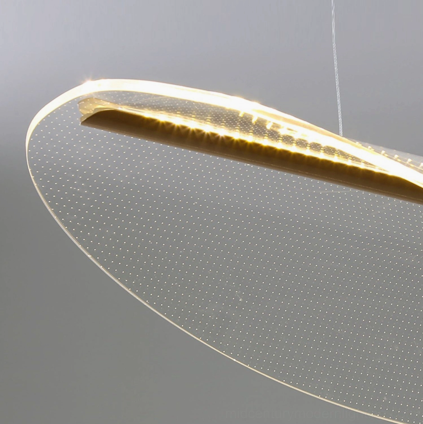 Frosted perforated pendant light with integrated LED showing cool light color temperature