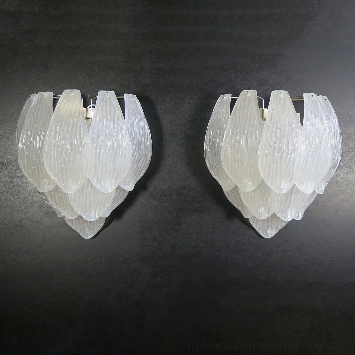Frosted petal sconce ambient lighting effect creating soft diffused glow on surrounding wall surface