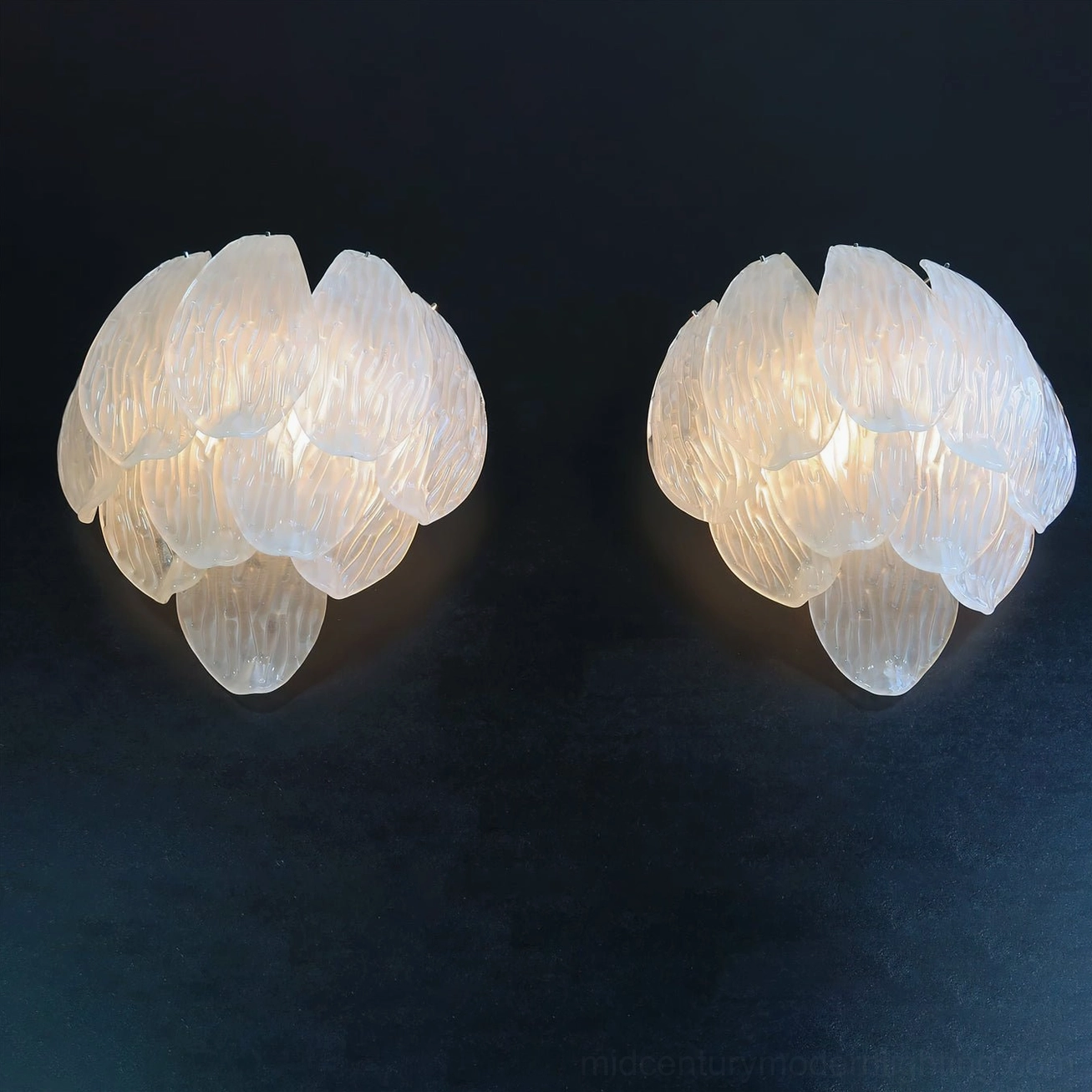 Frosted petal wall sconce showcasing translucent glass petals and warm light output design