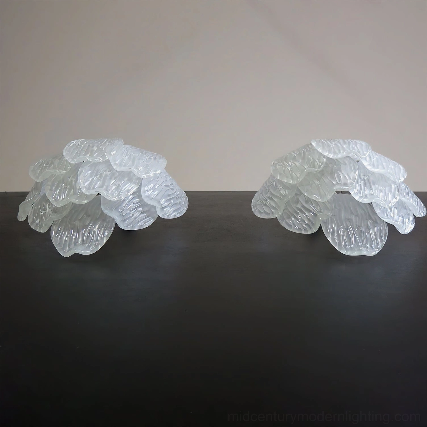 Frosted petal wall sconce side profile showing depth and sculptural petal layering architectural design