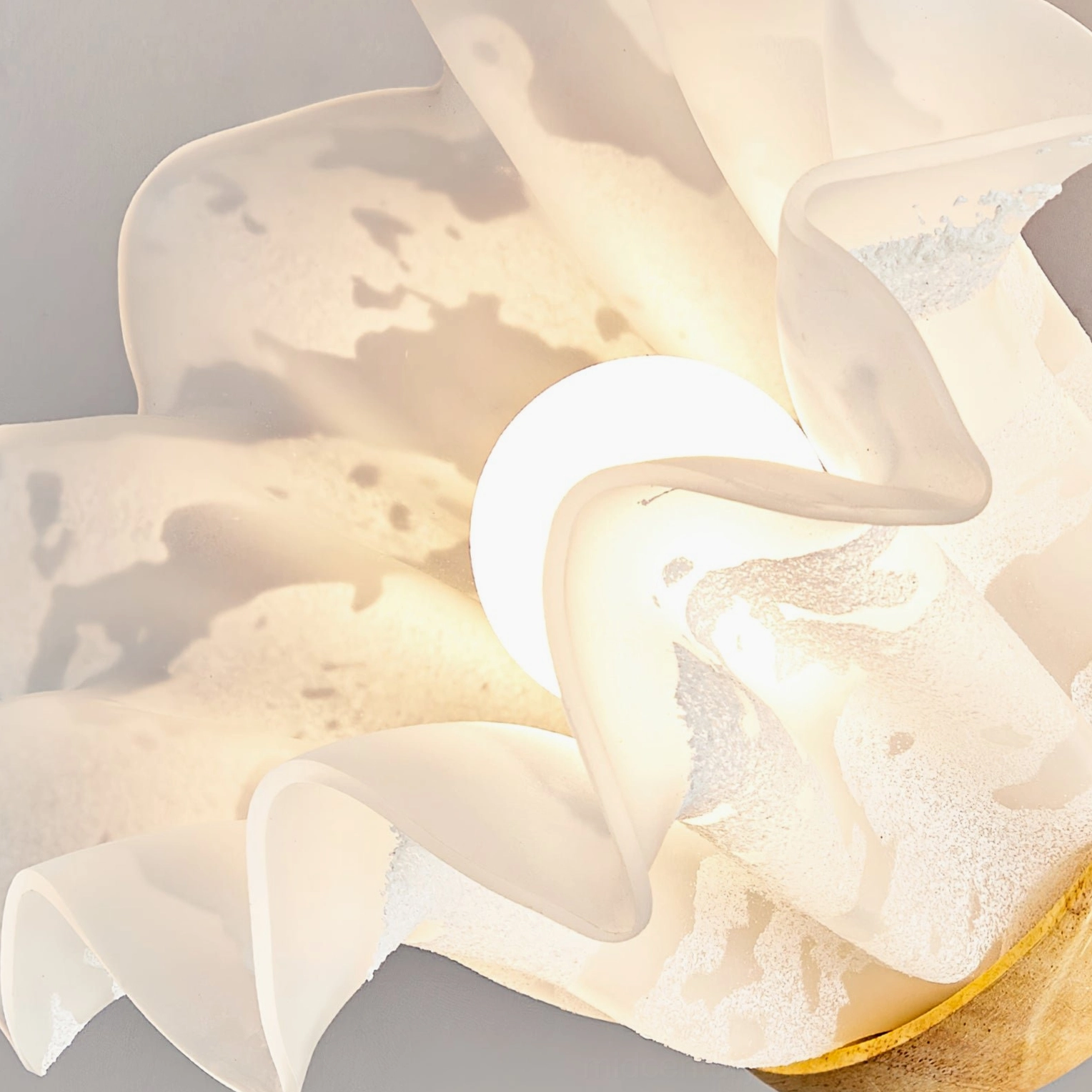 Frosted white acrylic petal shade with warm bulb, macro detail shot showing ruffled edge design