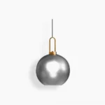 Studio view of frosted smoke gray spherical smoked glass pendant lamp with brass hardware, mid-century modern design