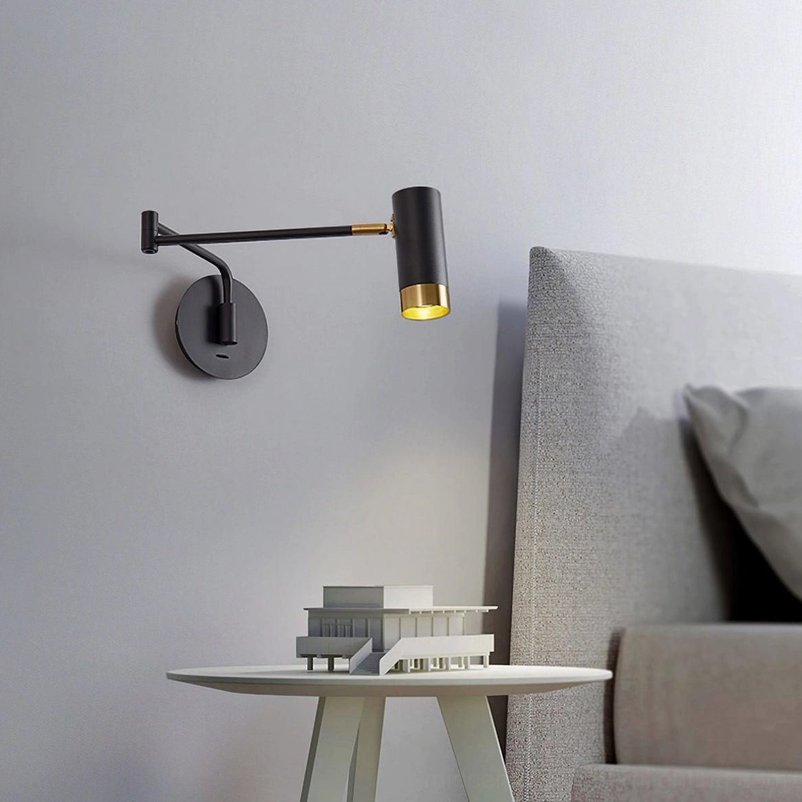 Directional swing arm feature of Fumi wall sconce demonstrating adjustable positioning
