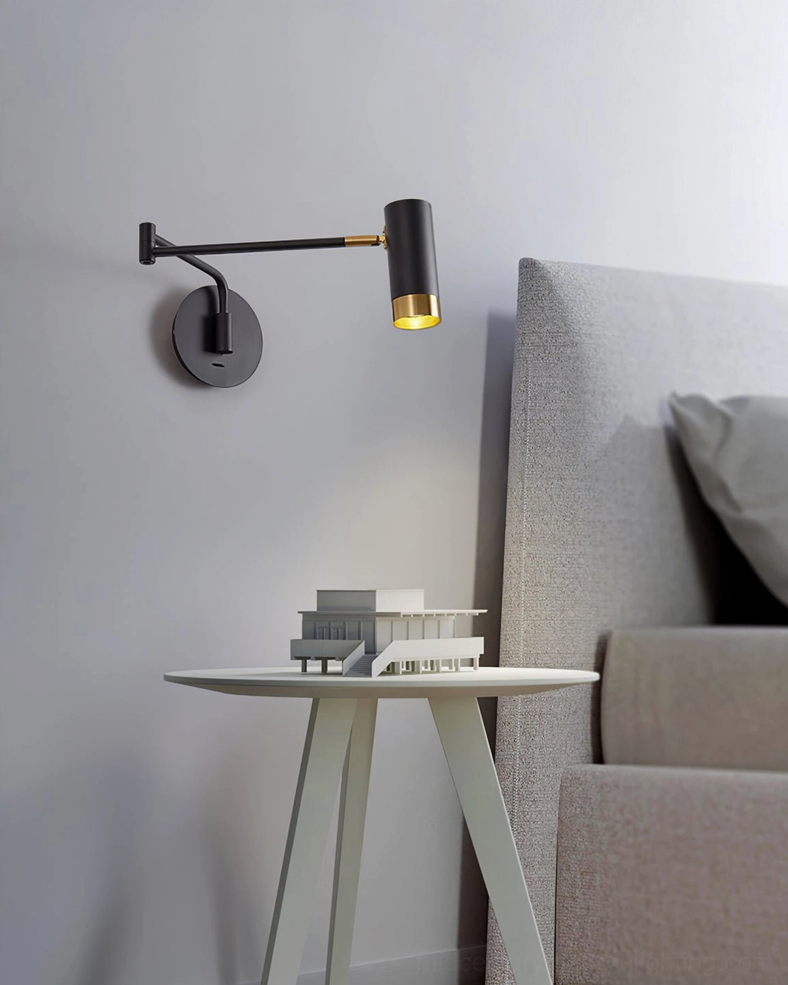 Black and gold Fumi articulating wall sconce in compact living room lounge setting