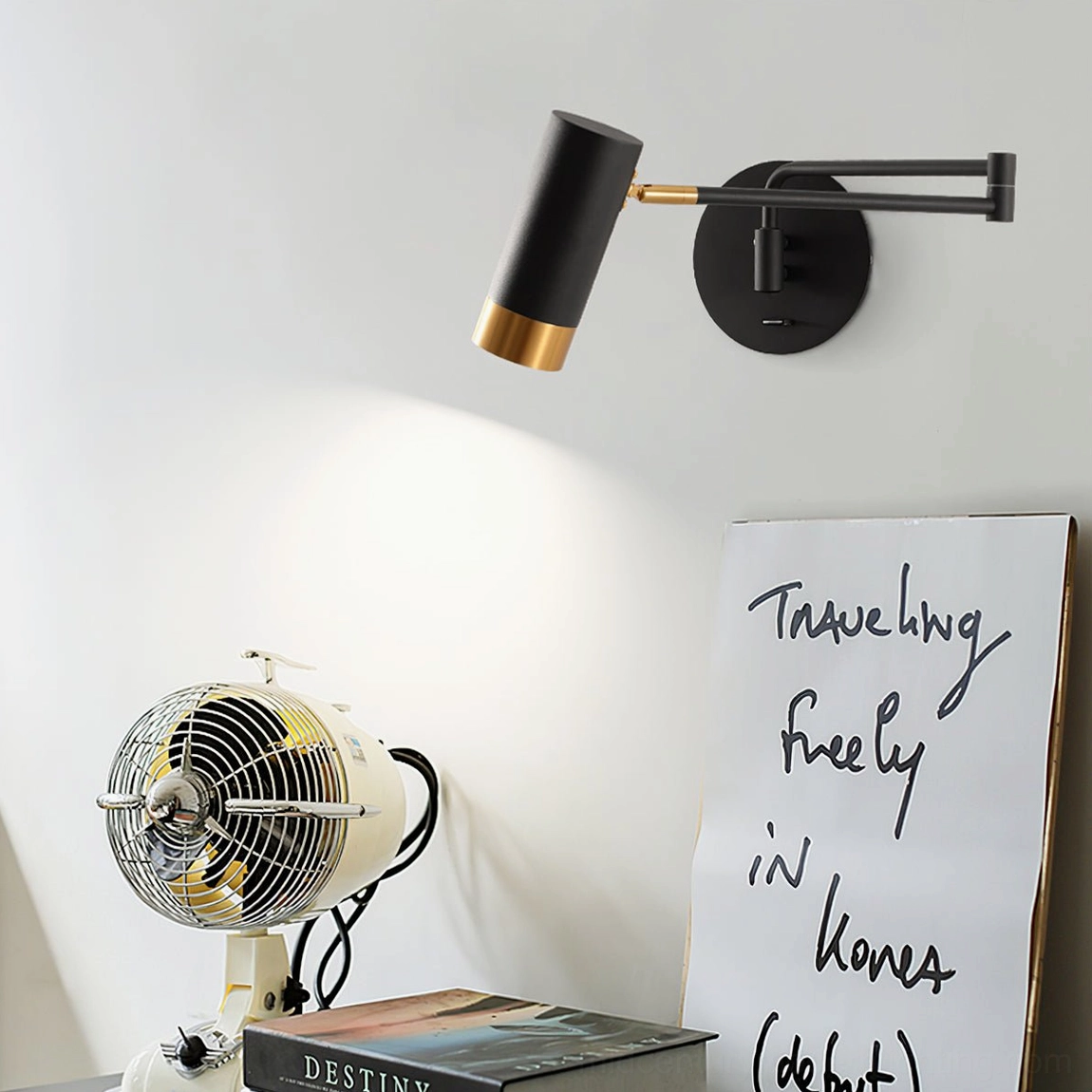 Black and gold Fumi swing sconce in modern Nordic home office corner with minimal decor