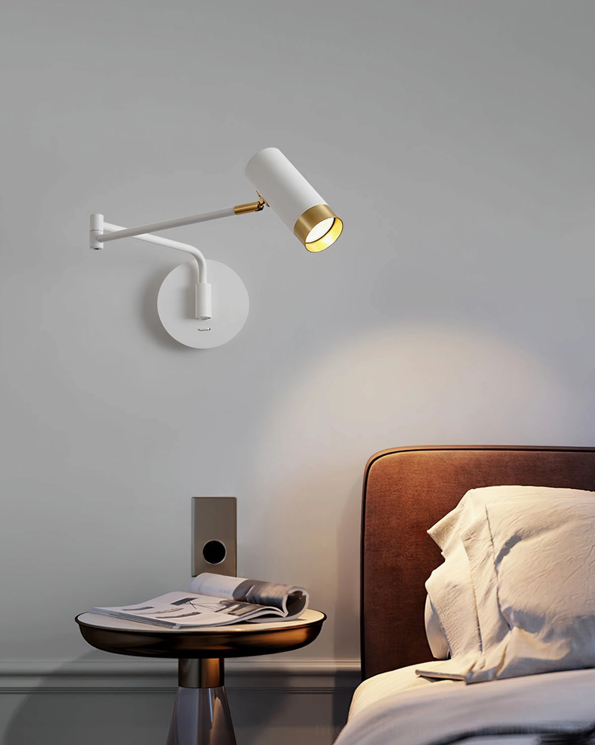 Close-up of Fumi swing arm sconce in bedroom setting providing adjustable task lighting