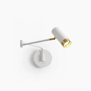 Fumi articulating swing wall sconce with white base and gold accents in minimalist studio setting